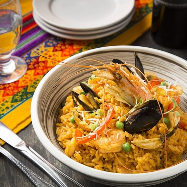 Aromas del Peru's Arroz con Mariscos, a seafood rice dish with shrimp, mussels, and peas.